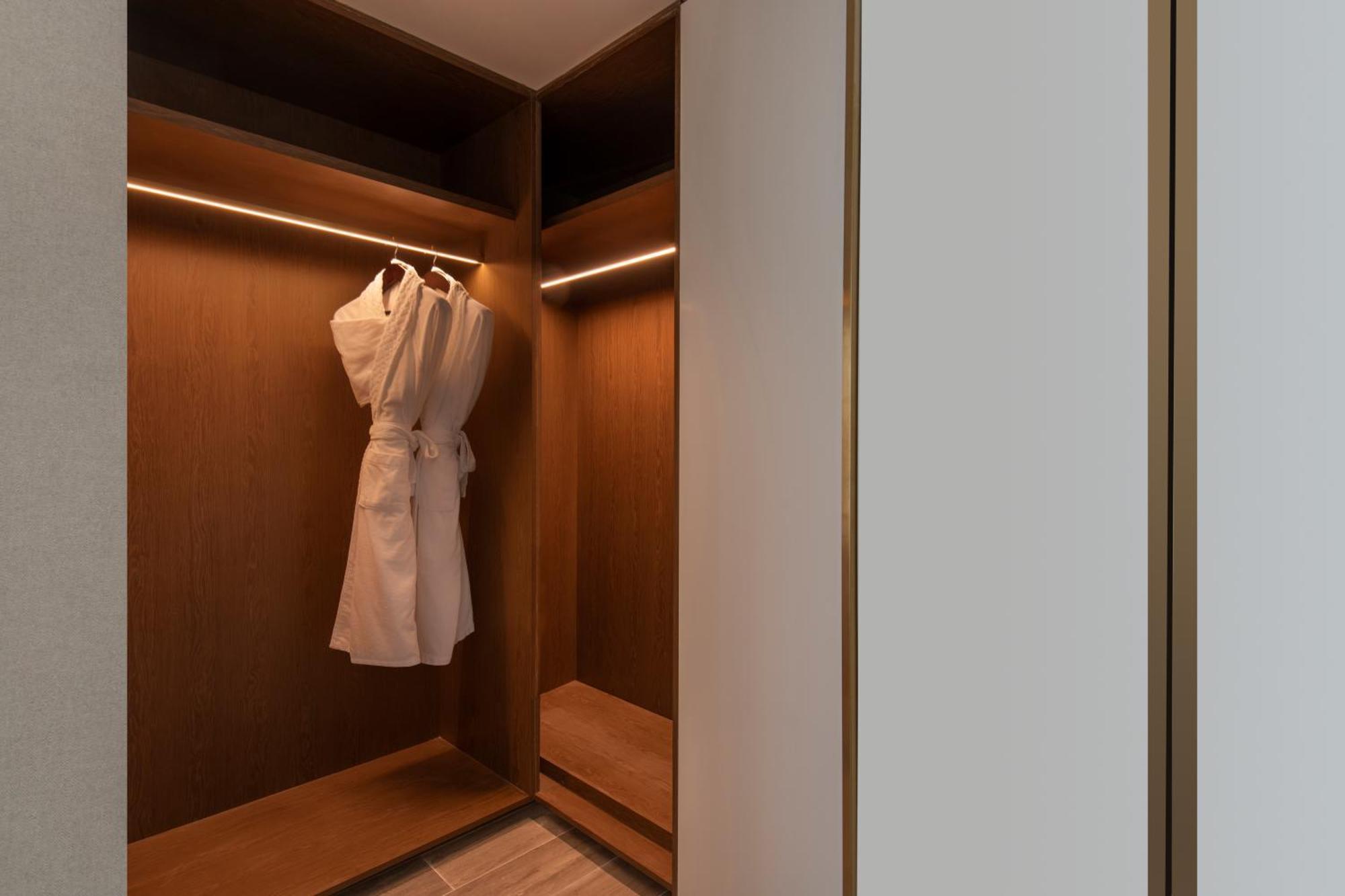 Rixos Gulf Hotel Doha Exteriör bild A bathrobe hanging in a closet